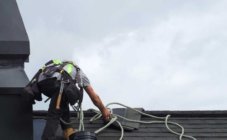 Homeowner checks gutters and attic areas for debris, moisture, and early roof damage.